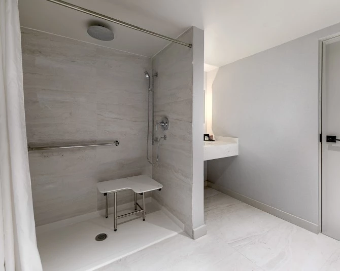 close up of accessible shower with seat and handlebars picture 4