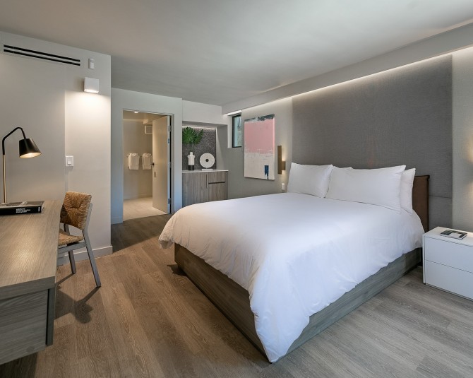 room with white bedding and modern light fixtures picture 0