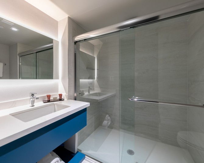 close up of blue sink with large walk in shower picture 1