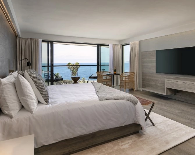king bed with flat-screen TV and ocean view picture 0