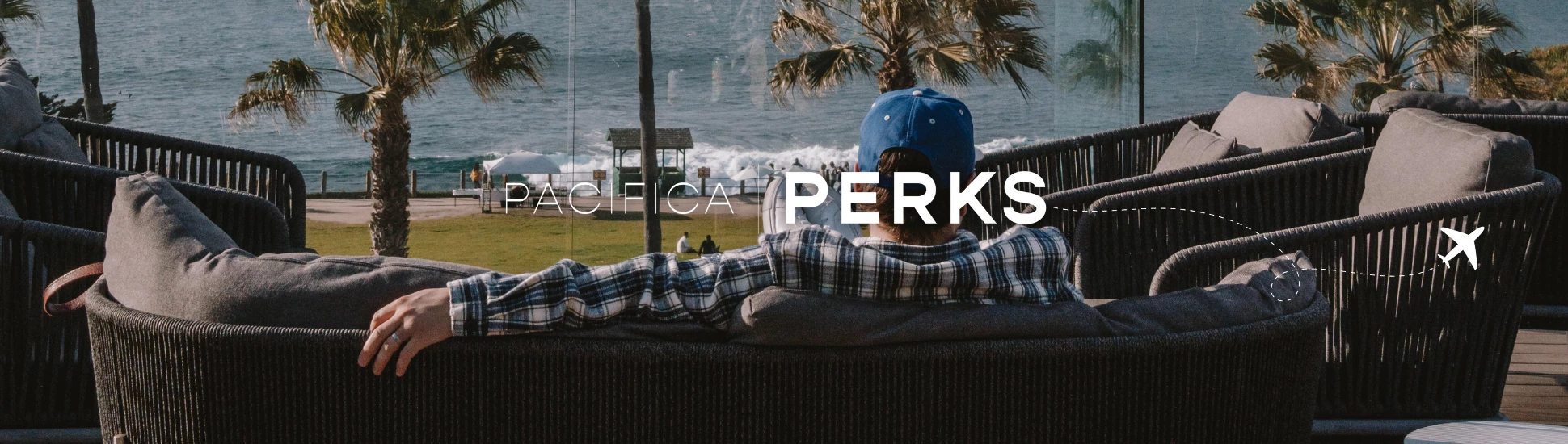 a person sitting on a couch looking out at the ocean