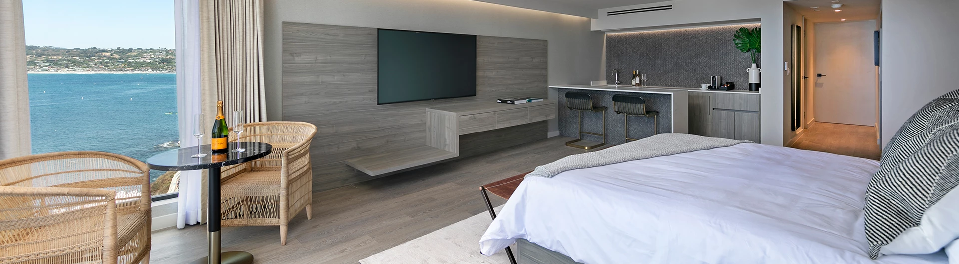 a room with a bed and a table with a tv in the background