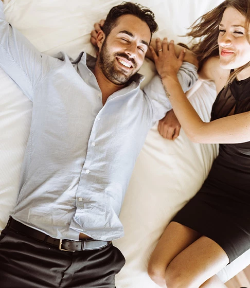 couple laughing in bed