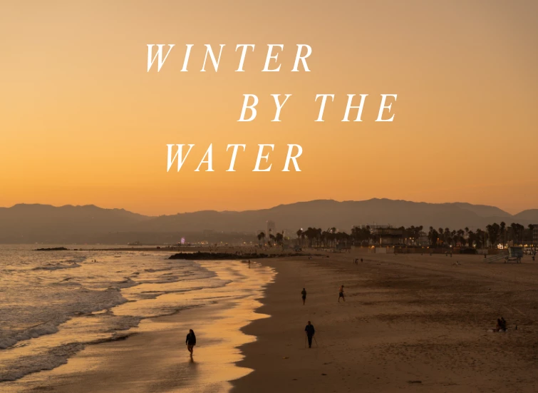 a beach with people walking on the beach