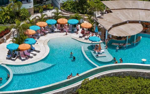 a pool with umbrellas and people in it