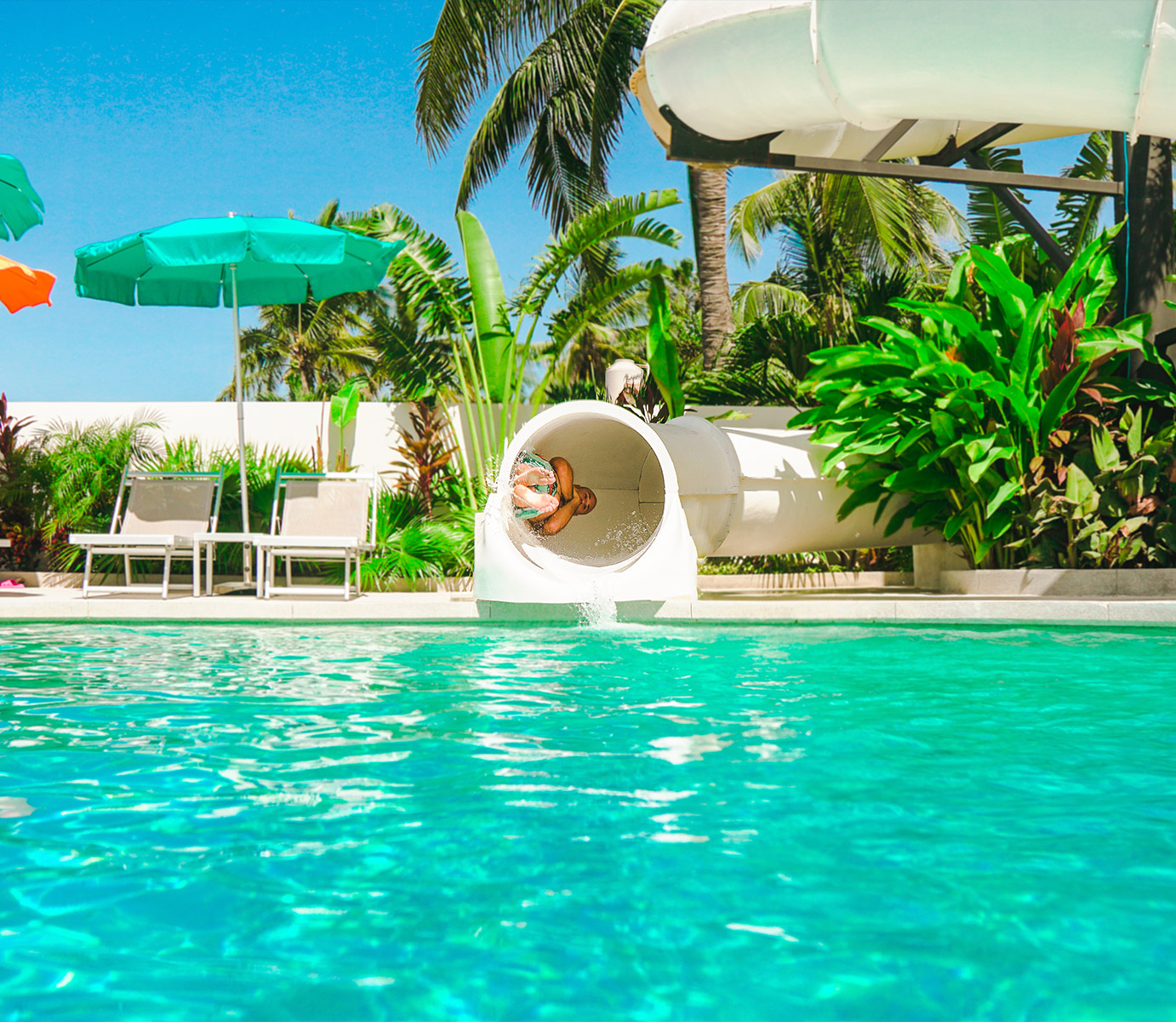 a pool with chairs and umbrellas