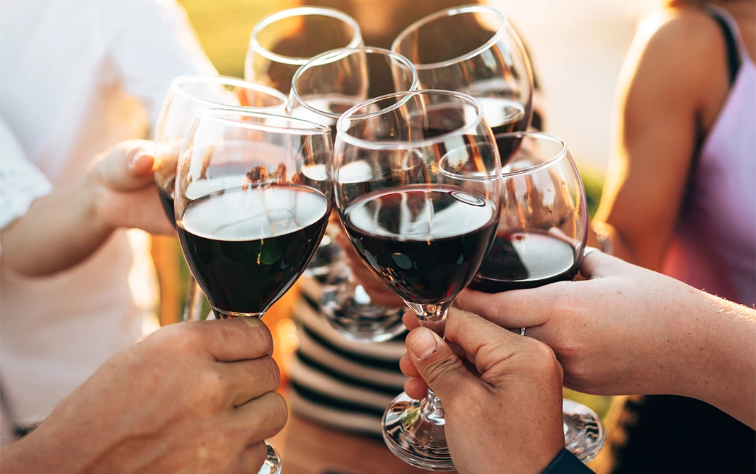 a group of people holding wine glasses