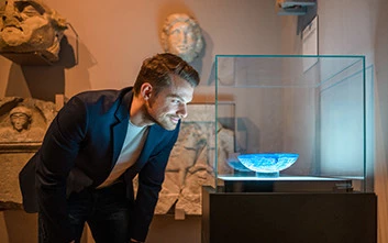 a man looking at a painting