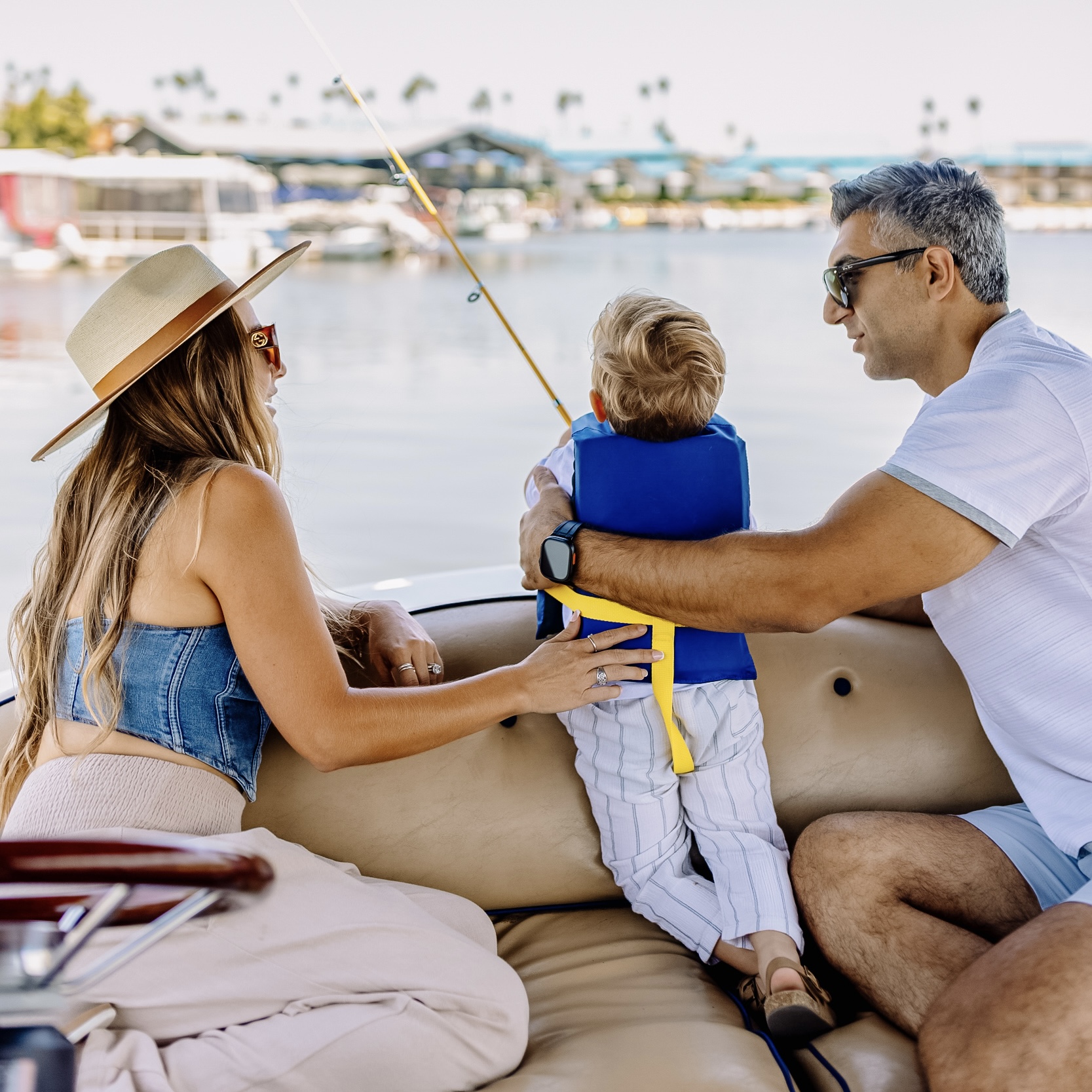 a man and woman sitting on a boat with a child