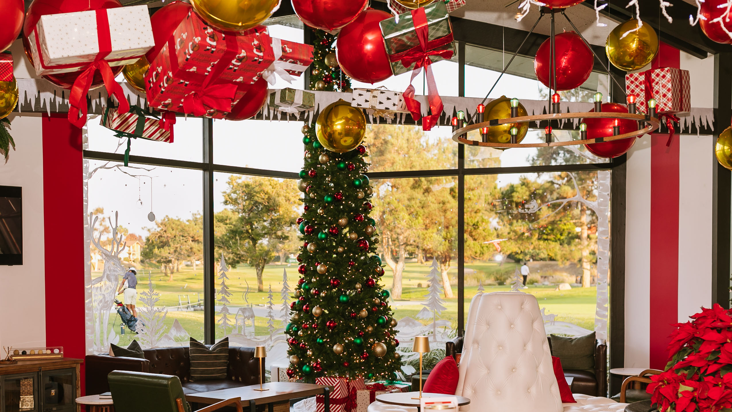 a christmas tree with presents from the ceiling