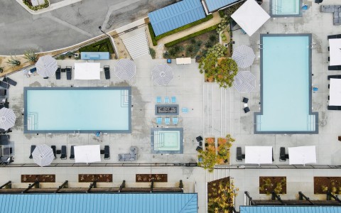 a pool and umbrellas on a building