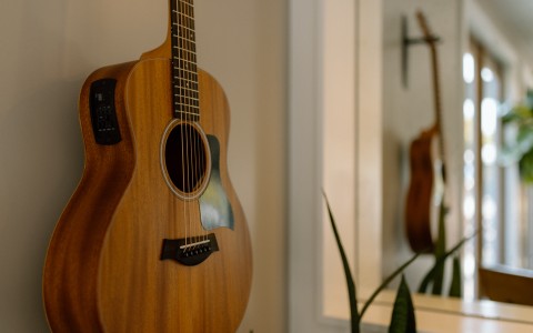 a guitar leaning against a wall
