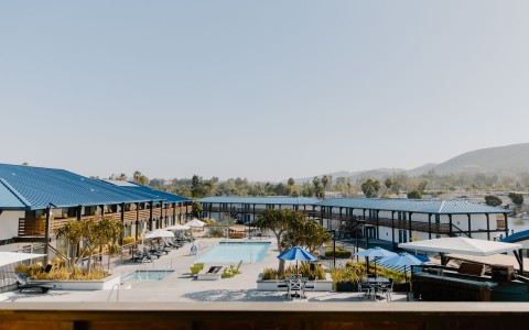 a pool and umbrellas in a hotel