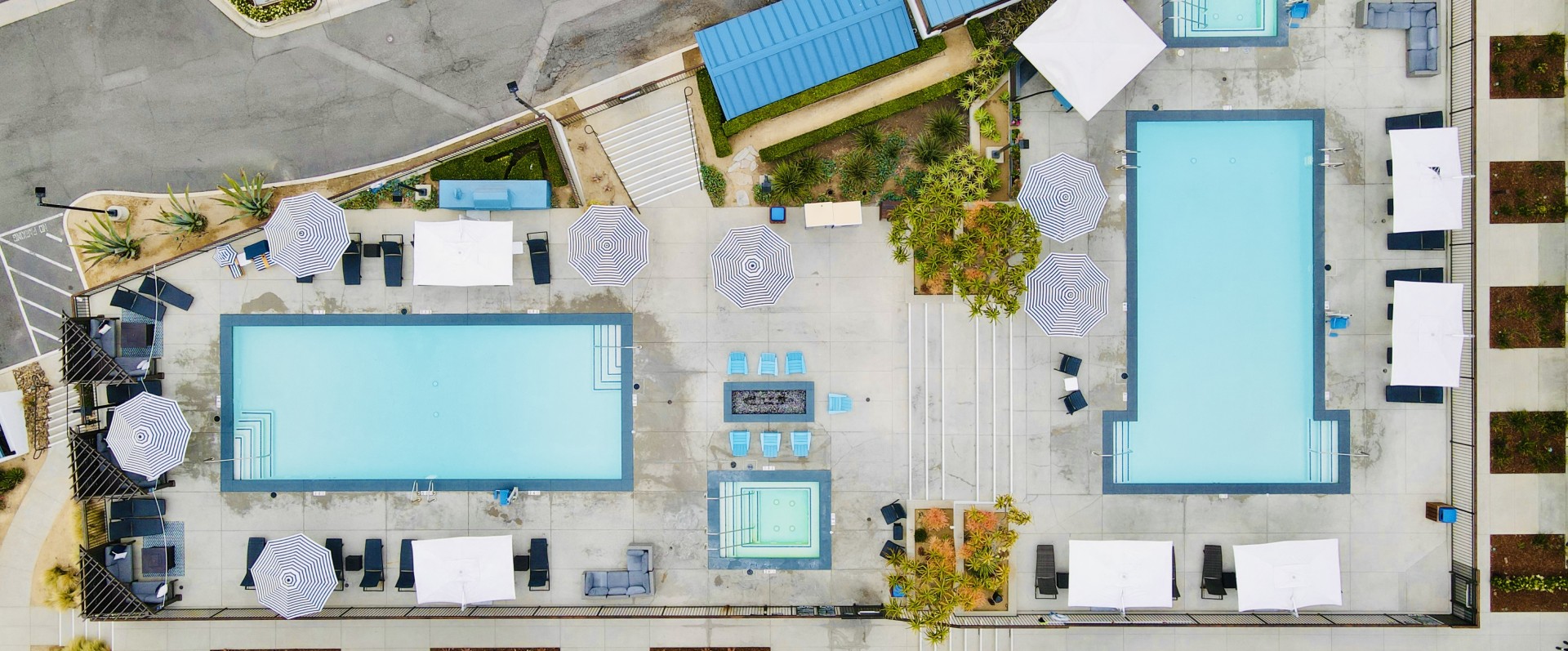an aerial view of a pool and umbrellas