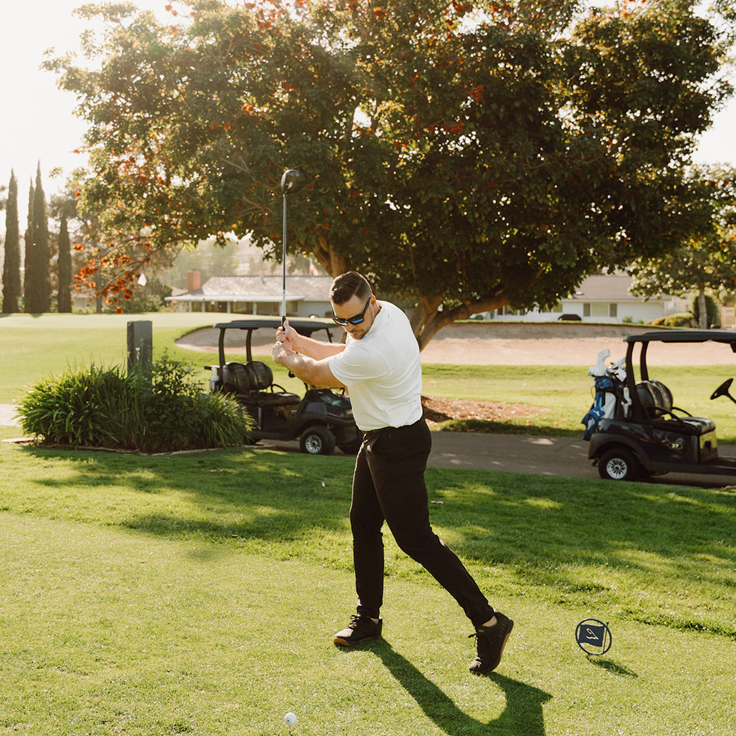 a man swinging a golf club