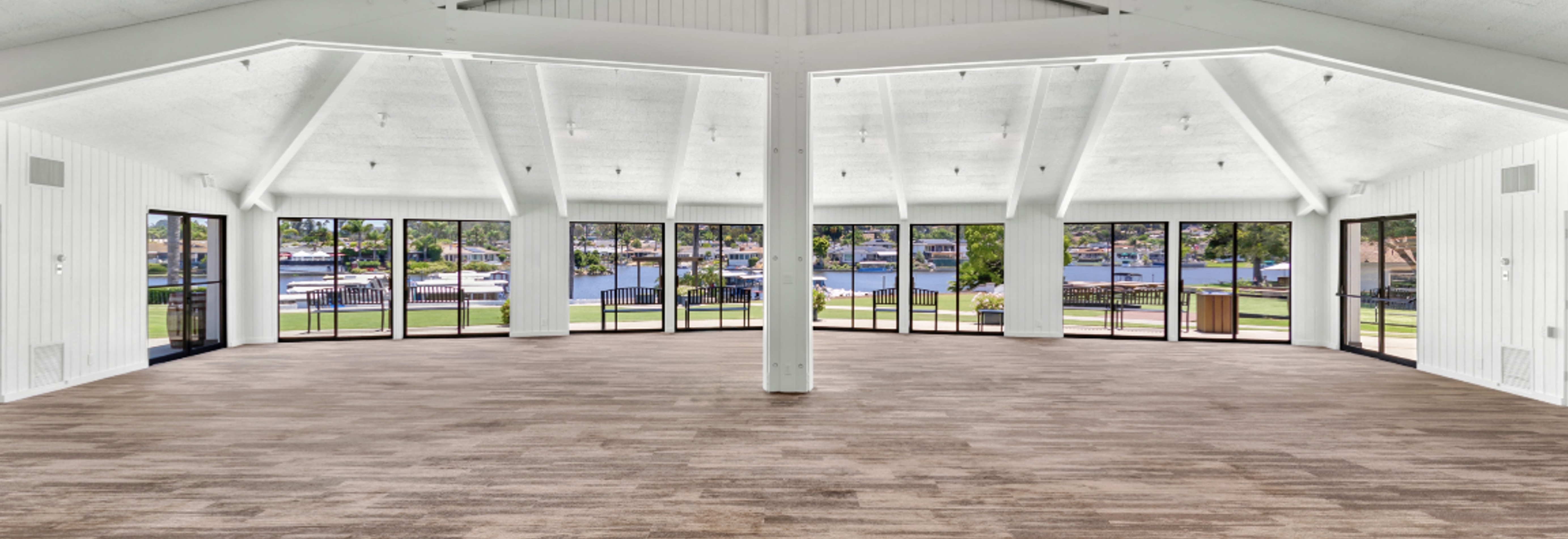 a large room with windows and a view of water