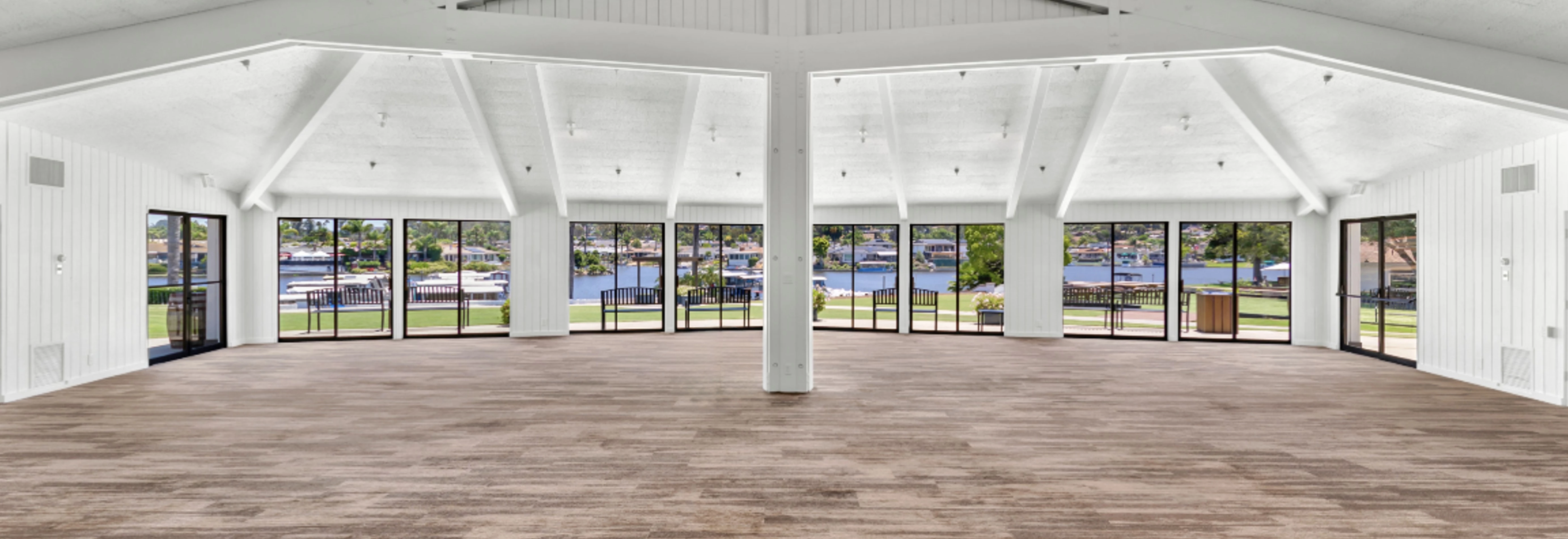 a large room with windows and a view of water