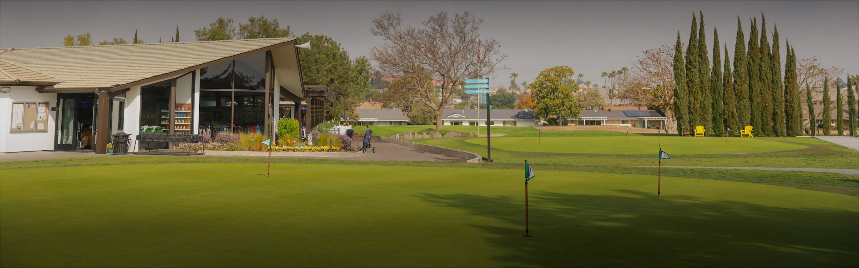 a golf course with a building in the background