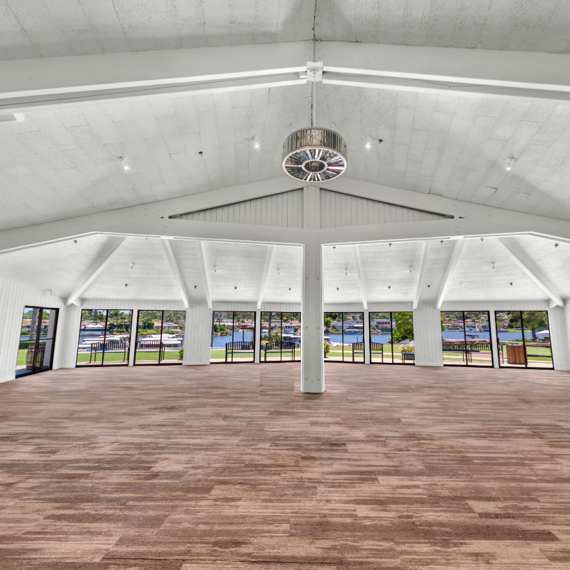 a large room with windows and a wood floor