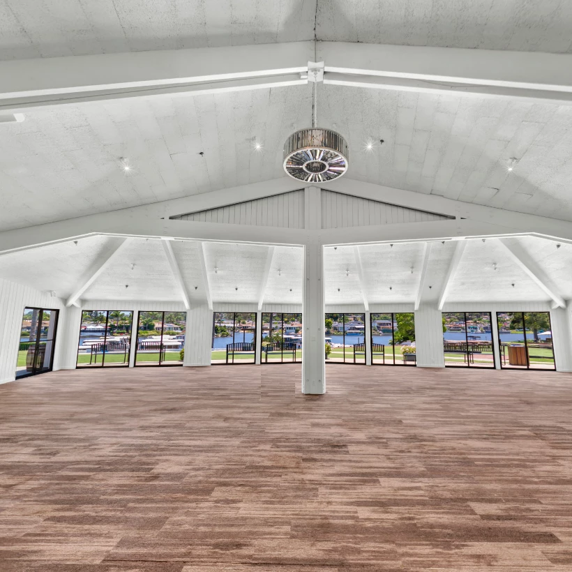 a large room with windows and a wood floor