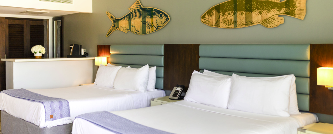 a room with two beds and a telephone