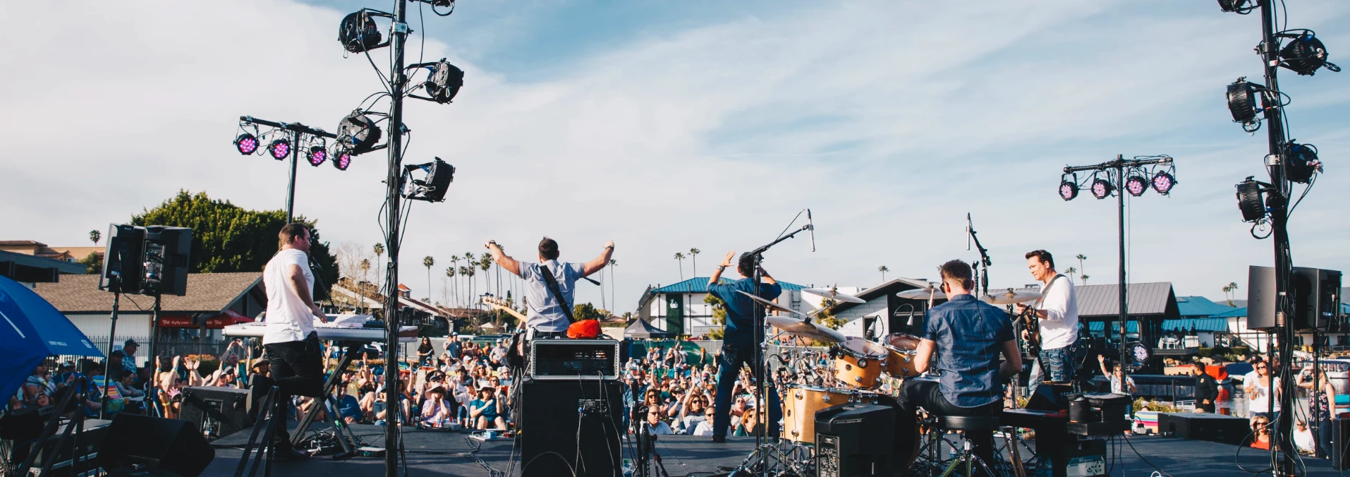 a group of people on a stage with microphones and speakers
