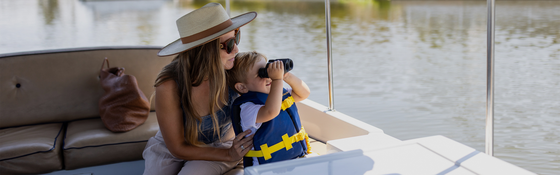 a woman and child on a boat looking through binoculars