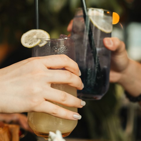 a pair of hands holding drinks