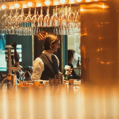 a man standing behind a bar