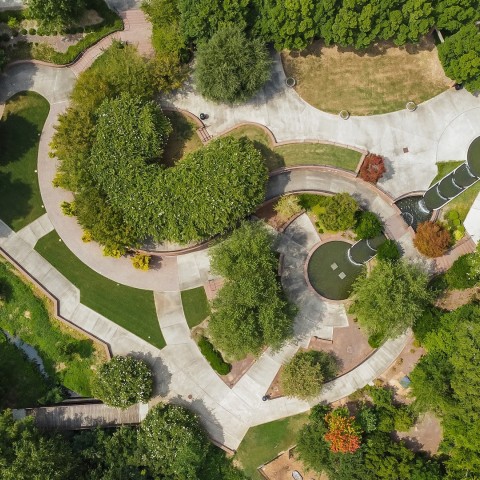 aerial view of a park with trees and a fountain