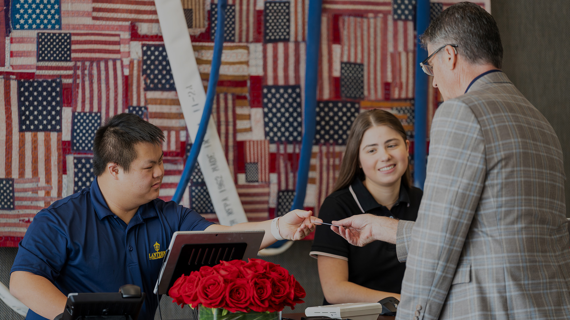 a man handing a credit card to a woman
