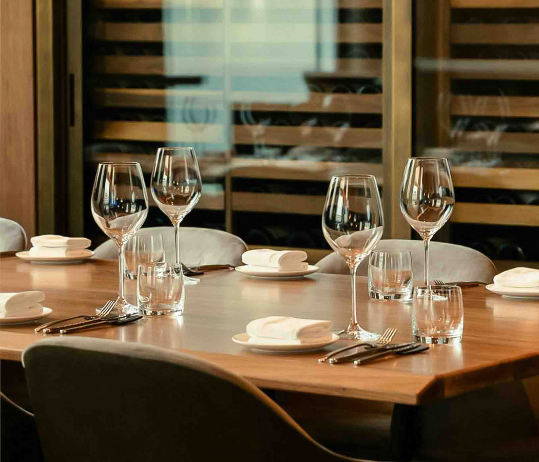 a table with glasses and utensils