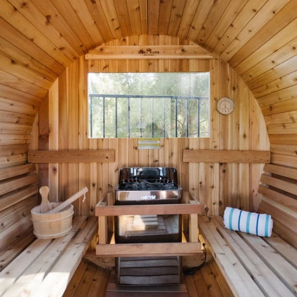 a wooden sauna with a bucket and a sink