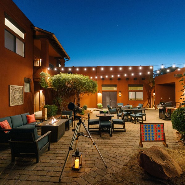 a patio with chairs and tables and a game board