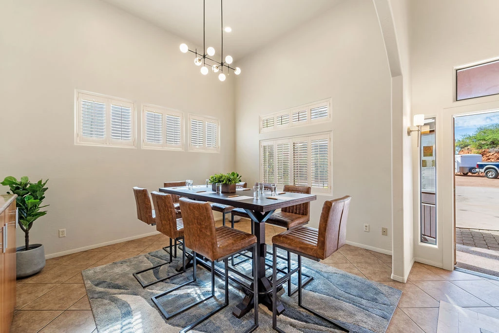 a dining table with brown chairs in a room