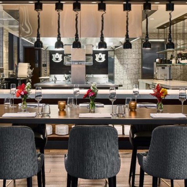 a restaurant with a long table and chairs