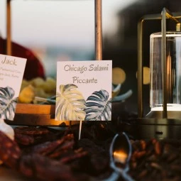 charcuterie table labeled with the different meats and cheeses