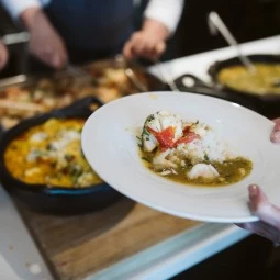 someone making a plate from the cooking class demonstration