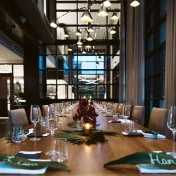 large dining table set with leaf name tags and wine glasses
