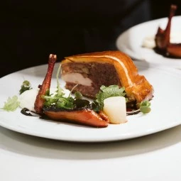 meat pastry dish with green garnish