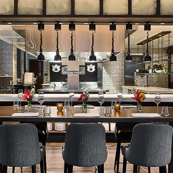 a dining room with a long table and chairs