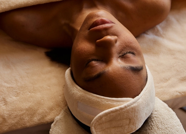 a woman lying down with a towel around her head