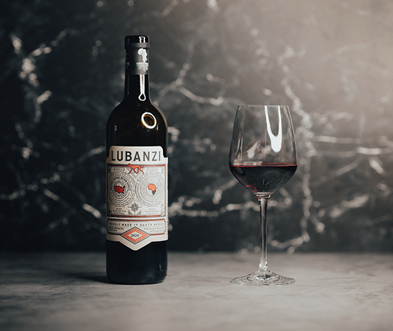 a bottle of wine next to a glass of wine