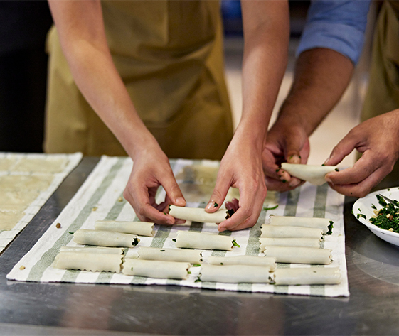 a group of people making food