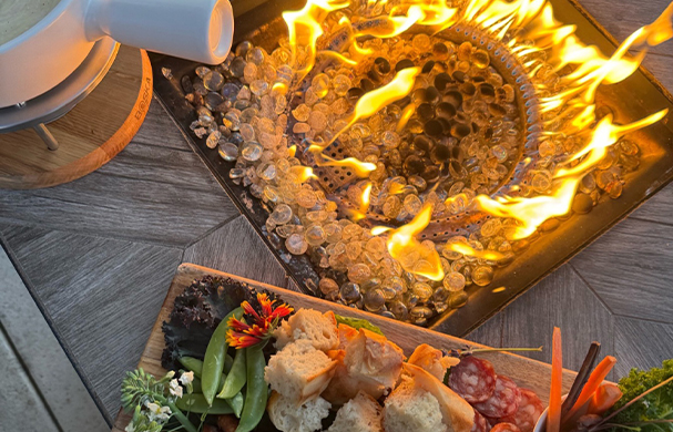 a plate of food on a fire pit