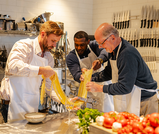 a group of men making pasta