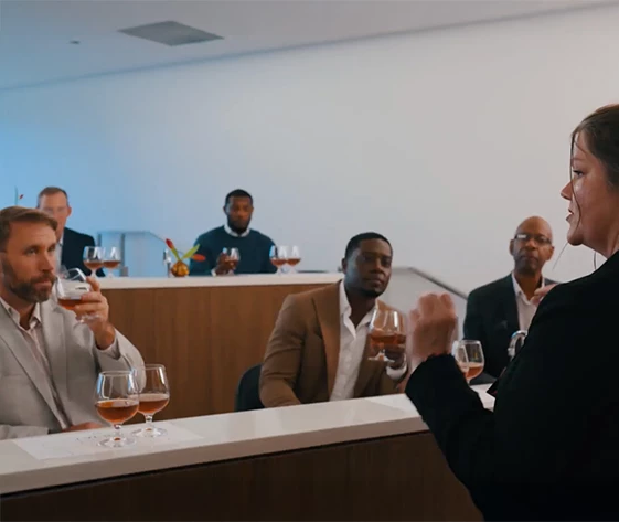a group of men sitting at a bar
