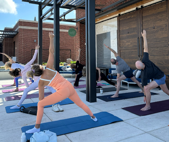 a group of people doing yoga outside