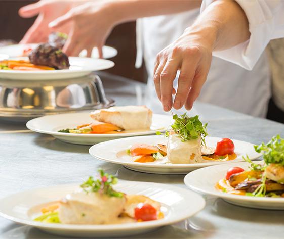 a chef putting food on plates