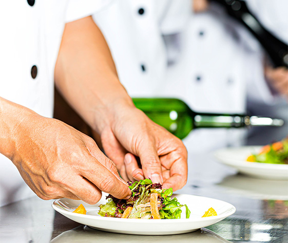a chef preparing food on a plate
